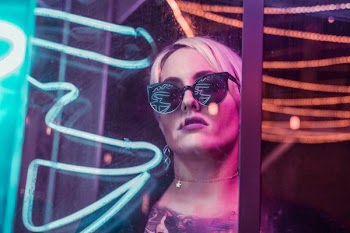 woman wearing black sunglasses through glass