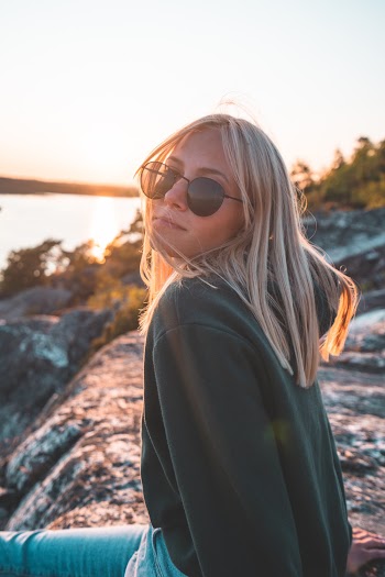 Woman Wearing Black Sweater and Sunglasses