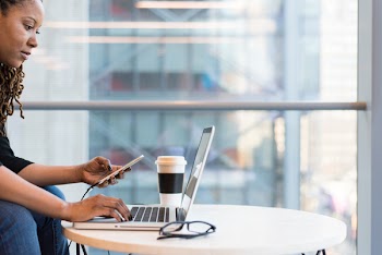 Woman Wearing Black Sweater Using Laptop Computer Inside the Room