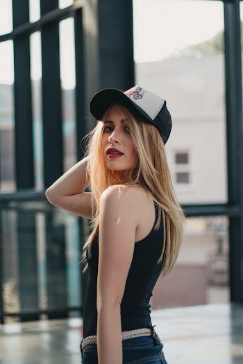 Woman Wearing Black Tank Top and White Fitted Cap