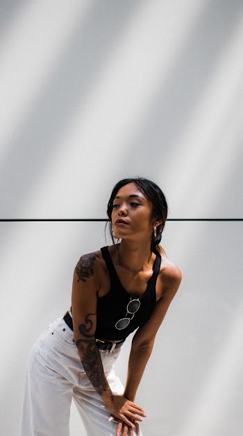 Woman Wearing Black Tank Top and White Pants Posing