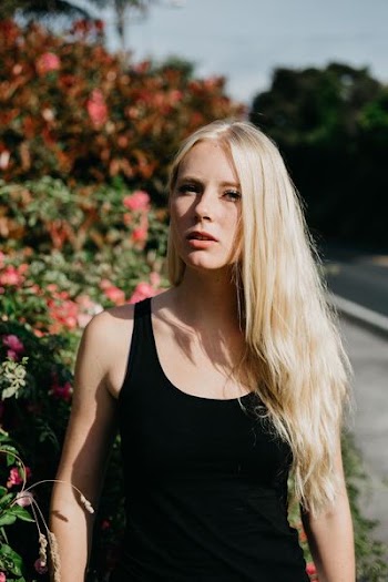 woman wearing black tank top in shallow focus photography