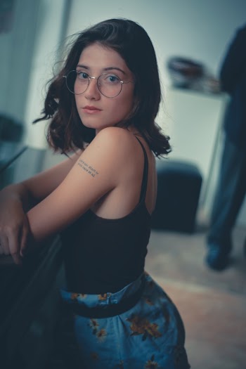 Woman Wearing Black Tank Top Leaning on Bench