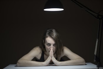 Woman Wearing Black Tank Top Leaning on Table