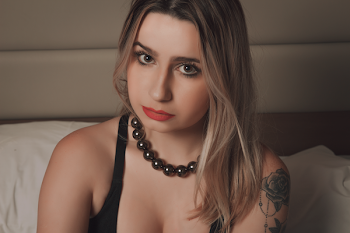 Woman Wearing Black Tank Top Sitting Near White Surface