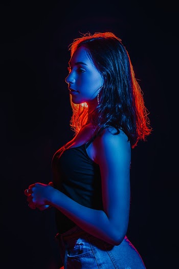 Woman Wearing Black Top and Blue Denim Bottoms