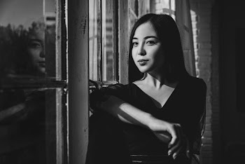 Woman Wearing Black Top Beside Window