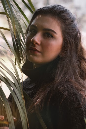 Woman Wearing Black Top Holding Green Leaves