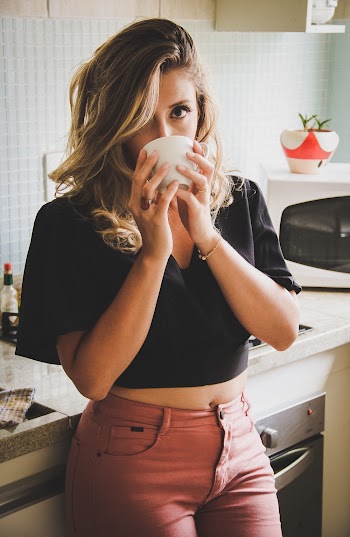 Woman Wearing Black Top Holding White Cup