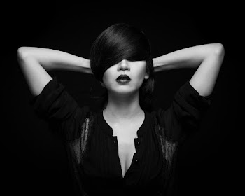 Woman Wearing Black Top With Hands On Her Head