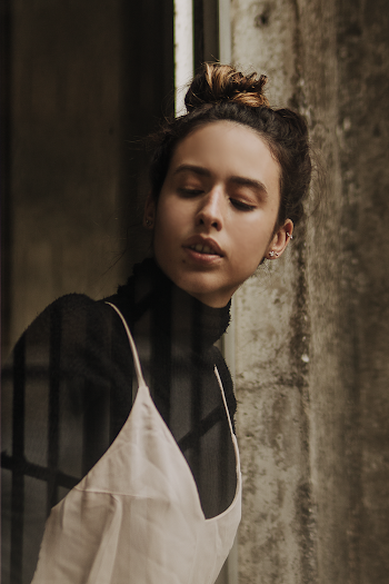 Woman Wearing Black Turtle-neck Sweater And White Spaghetti Strap Top