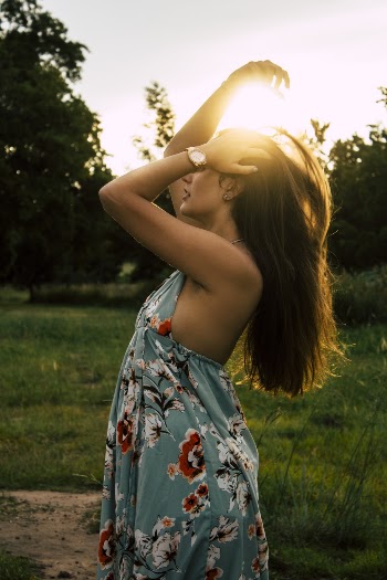 Woman Wearing Blue and Red Floral Sleeveless Dress Waving Hair