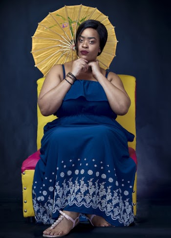 Woman Wearing Blue and White Floral Dress Holding Yellow Japanese Umbrella