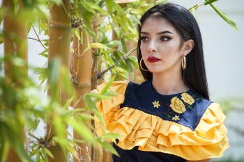 Woman Wearing Blue and Yellow Top Beside Bamboo Tree