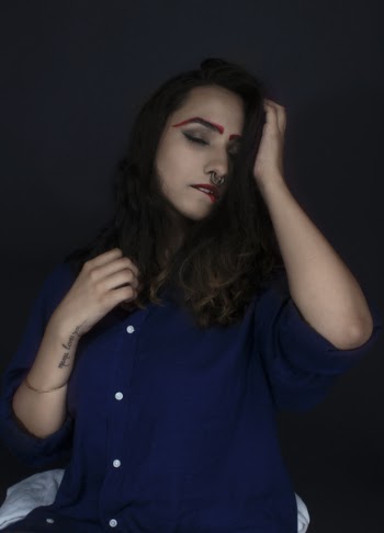 Woman Wearing Blue Button-up Blouse Bitting Lip