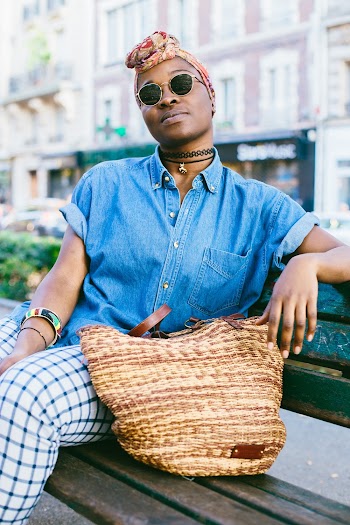 Woman Wearing Blue Chambray Top Sitting On Bench