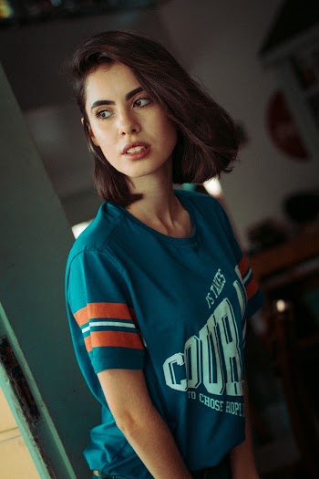 Woman Wearing Blue Crew-neck Top Standing Near Door