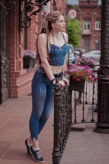 Woman Wearing Blue Crop Top Holding Handrails