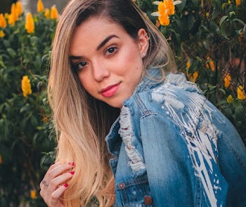 Woman Wearing Blue Denim Jacket Posing Near Yellow Petaled Flowers