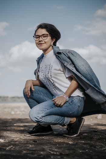Woman wearing Blue Denim Jacket squatting