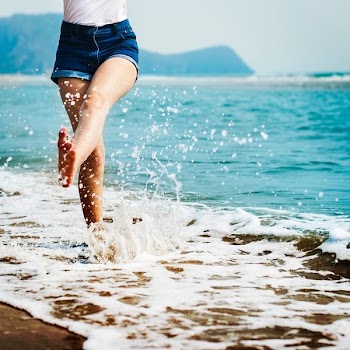 woman wearing blue denim shorts on seashore