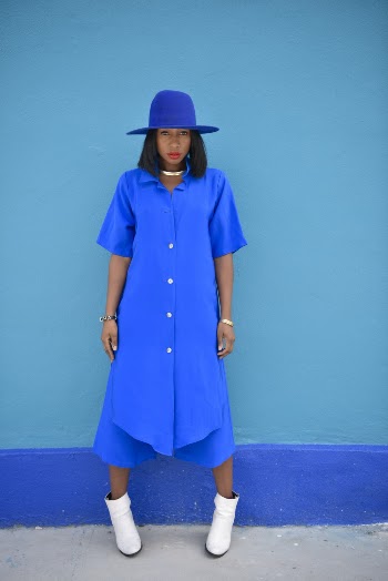Woman Wearing Blue Dress Standing Beside Blue Painted Wall