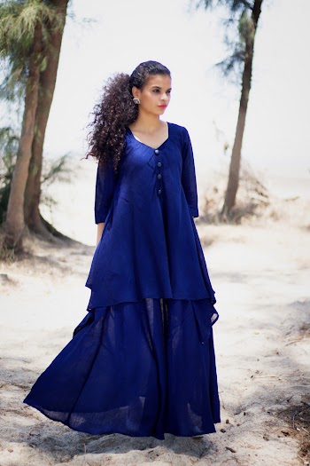 Woman Wearing Blue Dress Standing on Seashore