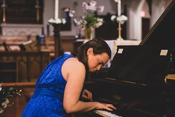 Woman Wearing Blue Floral Dress Playing Piano