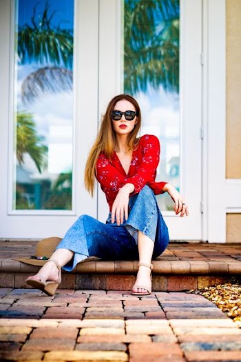 woman wearing blue jeans sitting on floor