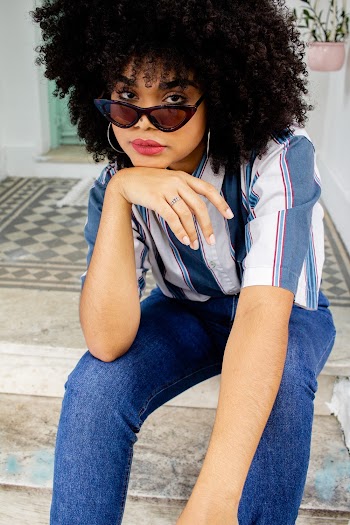Woman Wearing Blue Jeans With Hands on Her Chin