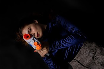 Woman Wearing Blue Long-sleeved Shirt Holding Nerf Gun