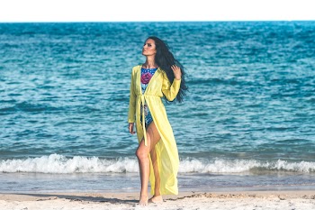 Woman Wearing Blue Monokini Standing on Beach Sand