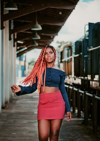 Woman Wearing Blue Off Shoulder Button-up Long Sleeved Crop Shirt And Pink Skirt