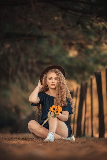 Woman Wearing Blue Off-shoulder Top Holding Yellow Sunflowers