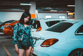 Woman Wearing Blue Printed Romper Standing Beside Car
