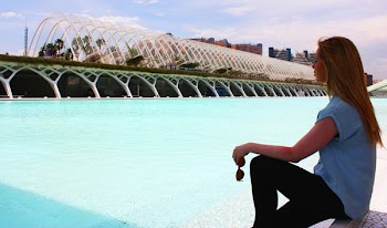 Woman Wearing Blue Shirt in Front of Green Lake