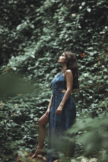 Woman Wearing Blue Sleeveless Side-slit Dress Surrounded by Green Leafed Plants