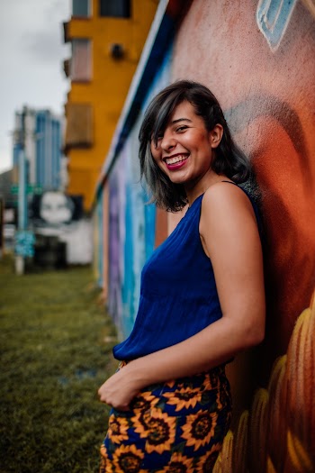 Woman Wearing Blue Tank Top and Floral Skirt