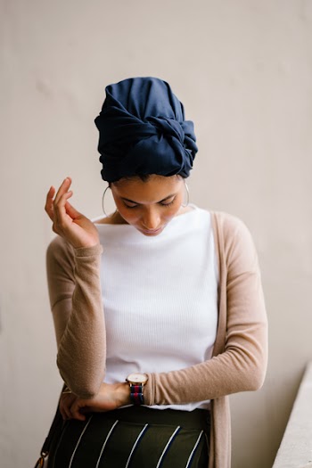 Woman Wearing Blue Turban, White Top and Brown Cardigan