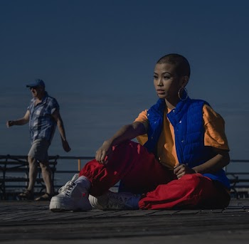 Woman Wearing Blue Vest Sitting on Floor