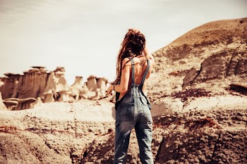 Woman Wearing Blue-washed Overalls Near Rock Formation