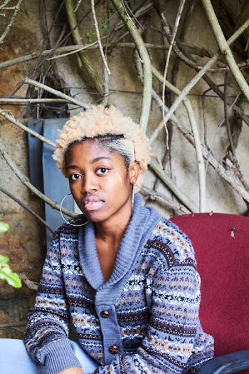 Woman Wearing Blue, White, and Brown Fair-isle Button-up Cardigan Sitting on Red Chair