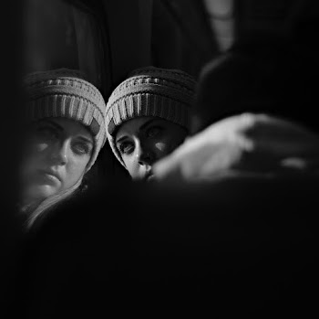 Woman Wearing Bonnet Leaning On Glass Window