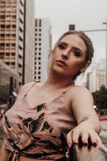 Woman Wearing Brown and Black Floral Crop-top Leaning on Railings