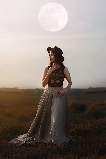 Woman Wearing Brown and Gray Dress Standing on Grass Field