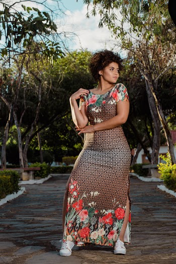 Woman Wearing Brown and Multicolored Floral Scoop-neck Cap-sleeved Dress Facing Left Side