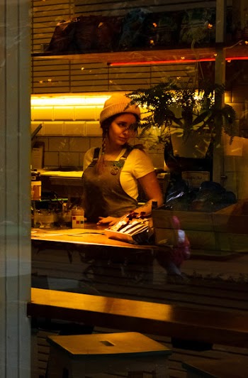 Woman Wearing Brown Apron Standing Near Table