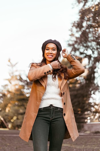 Woman Wearing Brown Coat, White Shirt, and Black Denim Jeans