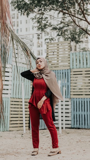 Woman Wearing Brown Headscarf Holding Neck