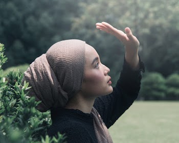 Woman Wearing Brown Headscarf Near Plant